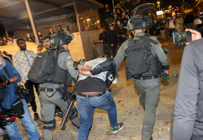Israeli security forces detain a Palestinian man outside the Damascus Gate in Jerusalem's Old City on April 4, 2022, during the Muslim holy month of Ramadan. (AFP)