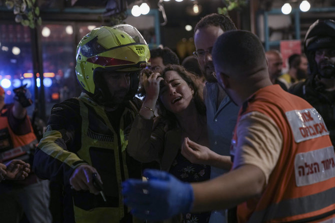 A woman reacts at the scene of a shooting attack In Tel Aviv, Israel, Thursday, April 7, 2022. Israeli police say several people were wounded. (AP)