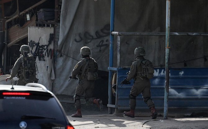 Israeli troops take position in the Nur Shams refugee camp near in the northern West Bank town of Tulkarem on April 10, 2022. (AFP)