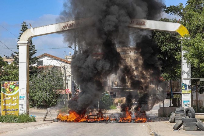 Tires are set aflame at an entrance to the Palestinian refugee camp of Jenin in the occupied West Bank on April 9, 2022. (AFP)