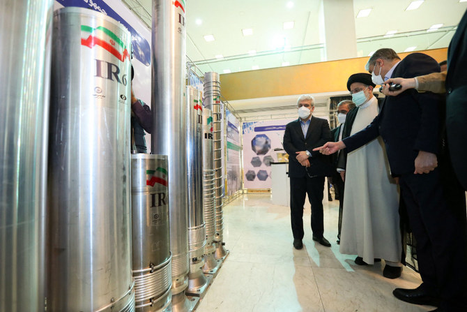 Iranian President Ebrahim Raisi (2-R) attending an event during the 