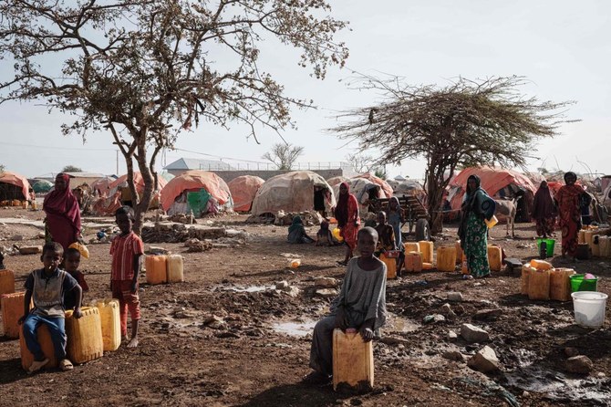 In this file photo taken on February 13, 2022 People wait for water with containers at a camp, one of the 500 camps for internally displaced persons (IDPs) in town, in Baidoa, Somalia. (AFP)