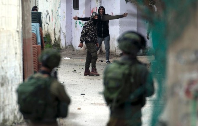 Israeli forces clash with Palestinian youths during a raid on the city of Jenin in the north of the occupied West Bank. (AFP)