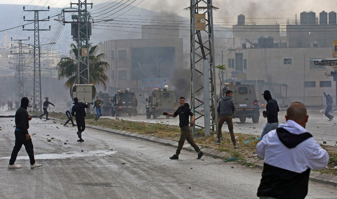 Israeli troops and Palestinians clash near the Jewish pilgrimage site of the Tomb of Joseph in Nablus in the occupied West Bank on April 13, 2022. (AFP/File)
