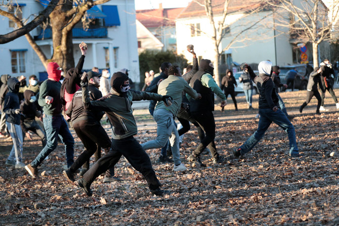 Counter-protesters throw stones at the police ahead of a demonstration planned by Danish anti-Muslim politician Rasmus Paludan in Orebro, Sweden, on April 15, 2022. (TT News Agency/via REUTERS)