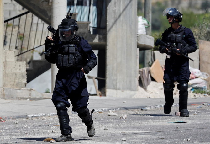 Israeli forces carry weapons during a clash in the Israeli-occupied West Bank April on 14, 2022. (Reuters)
