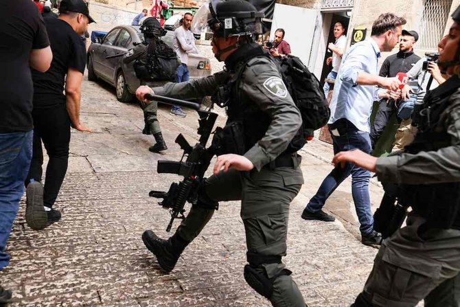 Israeli border police chase Palestinian youths in Jerusalem’s Old City, on April 17, 2022. (AFP)
