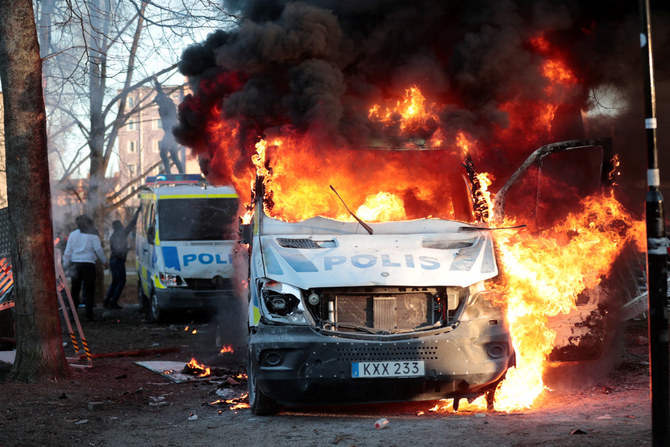 This photograph taken on April 17, 2022 shows a burning car near Rosengard in Malmo, Sweden, during riots sparked by a far-right group to publicly burn copies of the Qur'an. (Johan Nilsson / TT NEWS AGENCY / AFP)
