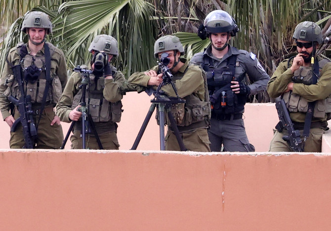 Israeli forces take aim during clashes with Palestinian demonstrators following a protest against a march by Israeli settlers to the wildcat settlement outpost of Homesh, Burqa, West Bank on April 19, 2022. (AFP)