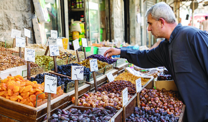 A customer buys spices, nuts and sweets at a shop in Amman. People are hoping their businesses will recover this year post COVID-19 restrictions. (Shutterstock)