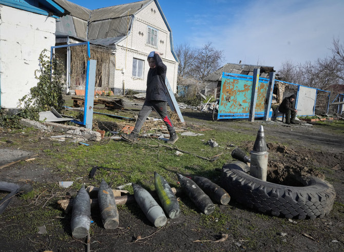 A boy walks by unexploded Russian shells in the village of Andriyivka close to Kyiv, Ukraine, Monday, April 11, 2022. (AP)