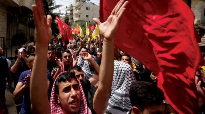 Palestinians attend the funeral of Muhammad Ali Ghoneim, who was shot dead by the Israeli army, in the town of Al-Khader, south of Bethlehem. (AFP)