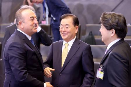 Turkish Foreign Minister Mevlut Cavusoglu (left), South Korean Foreign Minister Chung Eui-yong (centre) and Japanese Foreign Minister Yoshimasa Hayashi, speak at the start of the North Atlantic Council roundtable of NATO Foreign Ministers at the NATO headquarters in Brussels on April 7, 2022. (AFP)