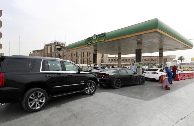 Iraqis crowd a petrol station to refuel amid a dispute between the authorities and owners of private stations, in Baghdad on Wednesday. (AFP)