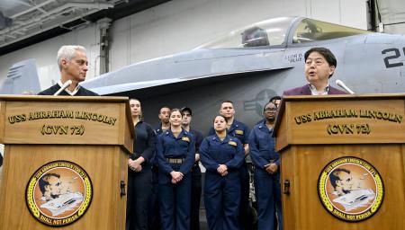 US Ambassador to Japan Rahm Emanuel (left) and Japan's Minister for Foreign Affairs Yoshimasa Hayashi (right) attend a press conference onboard the USS Abraham Lincoln aircraft carrier in the Pacific Ocean on April 23, 2022. (AFP)