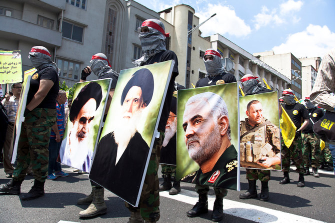 Iran's Revolutionary Guards parade along with photographs of their fallen commander, the notorious Qasem Soleimani, in Tehran on May 31, 2019. (Shuterstock)