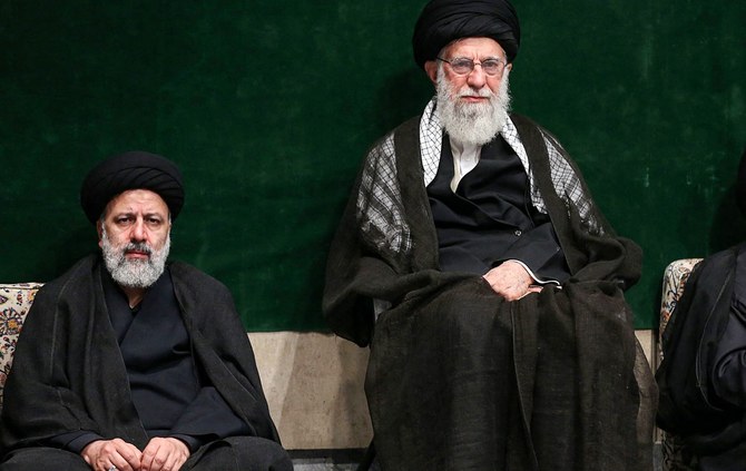 President of Iran Ebrahim Raisi, left, has sought to portray himself as a true supporter and follower of Supreme Leader Ayatollah Ali Khamenei. (AFP)