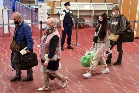 Ukrainians who have fled the war in their country arrive at Tokyo's Haneda Airport in Tokyo on April 5, 2022, following a visit to the Polish-Ukraine border by Japan's foreign minister. (AFP)