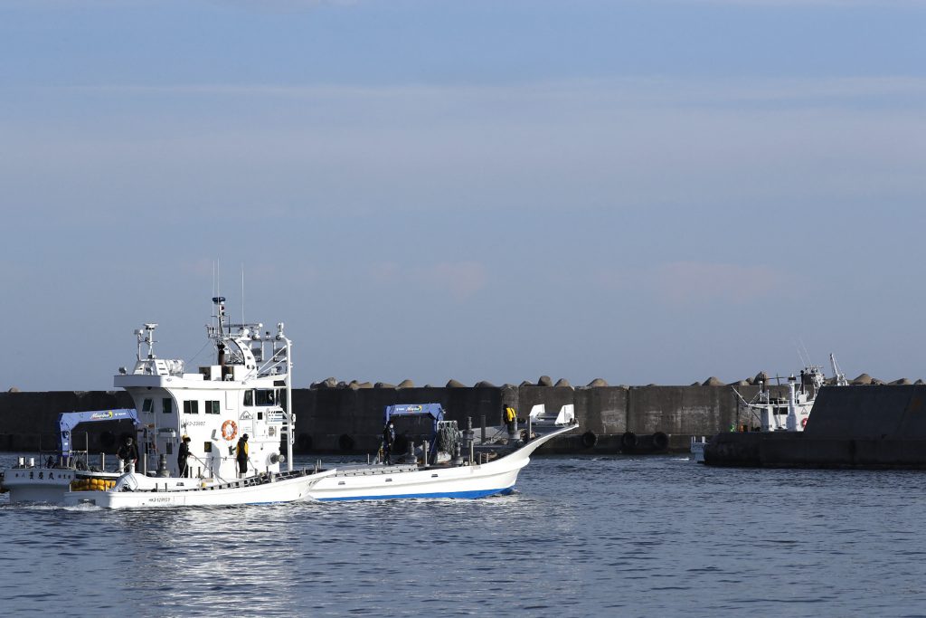 The boat, which currently lies on the seabed at a depth of some 120 meters, is expected to be moved onto a work vessel as early as Monday, after being lifted close to the sea surface by wires Sunday. (AFP)