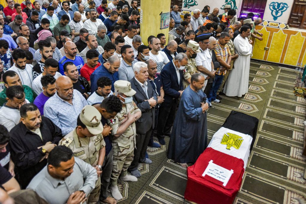 Mourners and soldiers perform prayers before the casket of Egyptian conscript Ahmed Mohamed Ahmed Ali, one of 11 soldiers killed in an attack claimed by the Islamic State group in the Sinai Peninsula. (AFP)