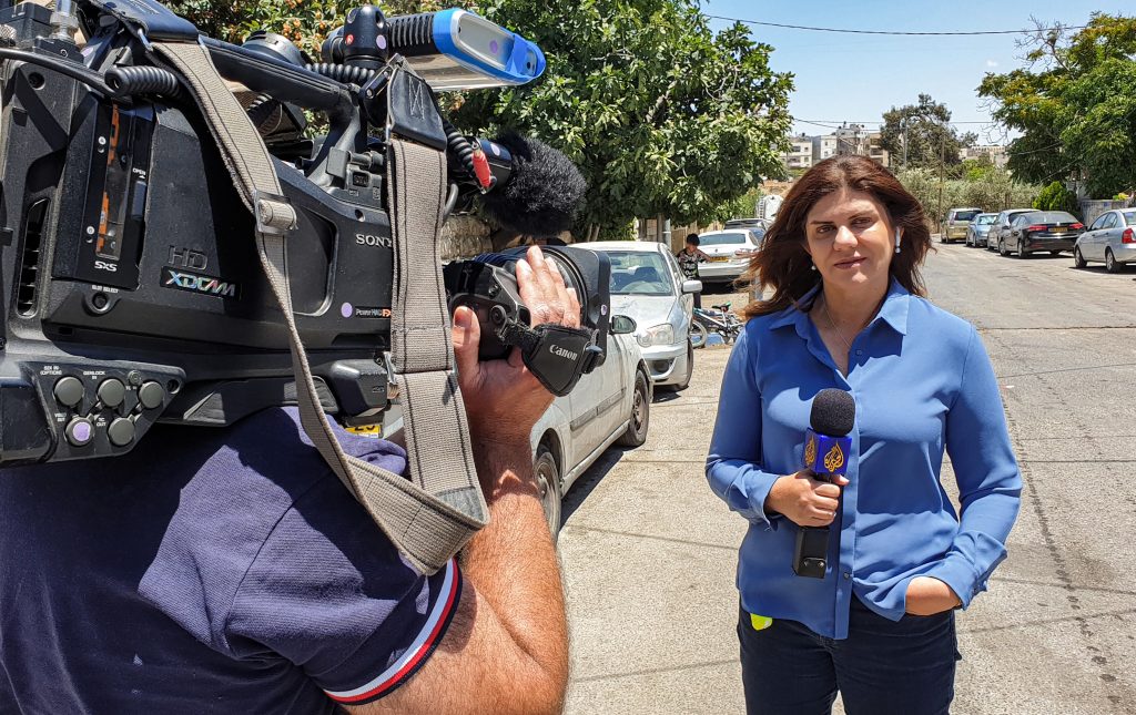 This handout file picture obtained from a former colleague of Al-Jazeera's late veteran TV journalist Shireen Abu Aqleh (Akleh), shows her reporting for the Qatar-based news channel from Jerusalem on May 22, 2021. (AFP)