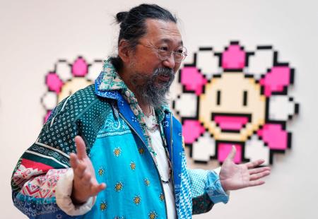 Artist Takashi Murakami stands in front of Murakami’s ‘Flowers’ during a press preview May 11, 2022 for “An Arrow through History” at Gagosian’s New York galleries. (AFP)