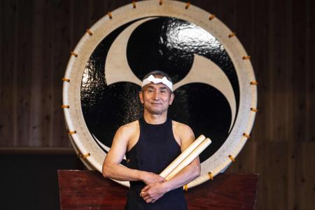 This photo taken on May 7, 2022 shows Japanese taiko drum performer Yoshikazu Fujimoto of the Kodo troupe posing for a photo after a perfomance on Sado island. (AFP)