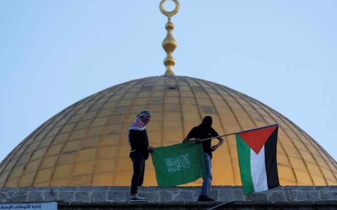 Masked Palestinians carry Palestinian and Hamas flags, Al-Aqsa Mosque compound, Old City Jerusalem, May 2, 2022. (AP Photo)