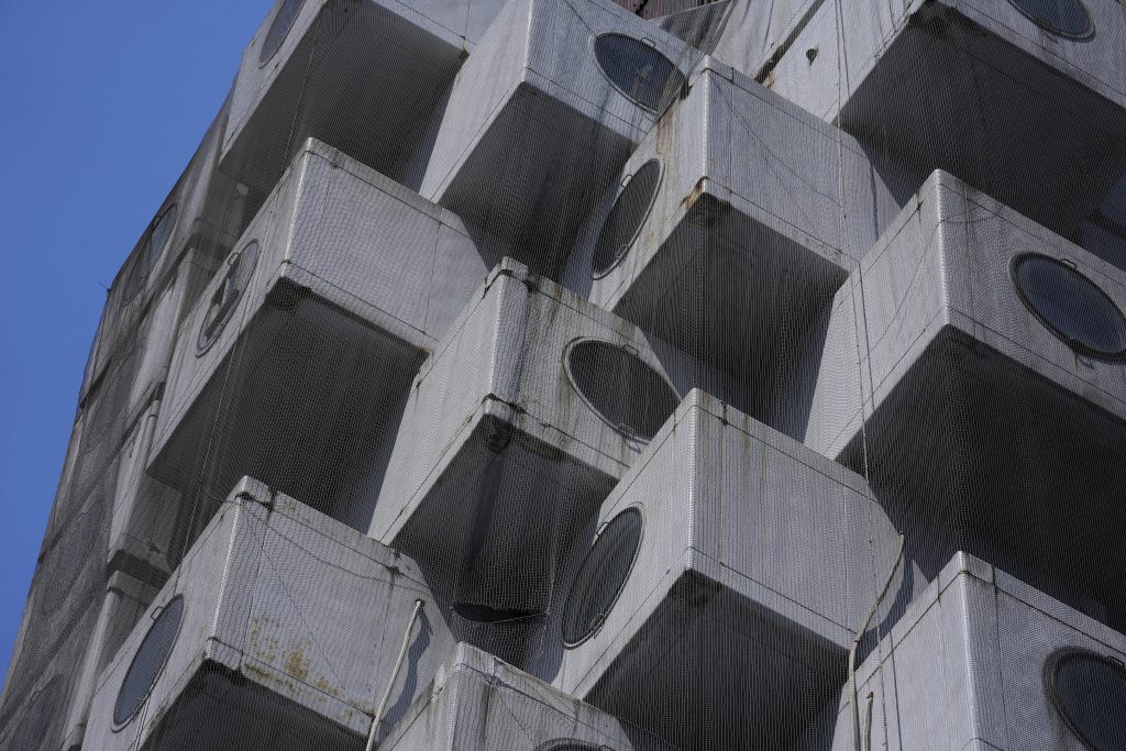 The Nakagin Capsule Tower, a famed capsule hotel in the Ginza district, shows its unique architecture of small cubic rooms, as parts of the capsule hotel was being demolished, in Tokyo. (File photo/AP)