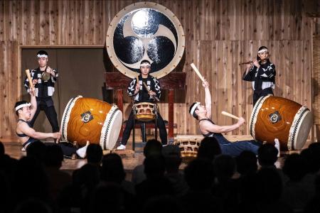 This photo taken on May 7, 2022 shows Japanese taiko drum performers, including Hana Ogawa (C), of the Kodo troupe taking part in a performance on Sado island. (AFP)