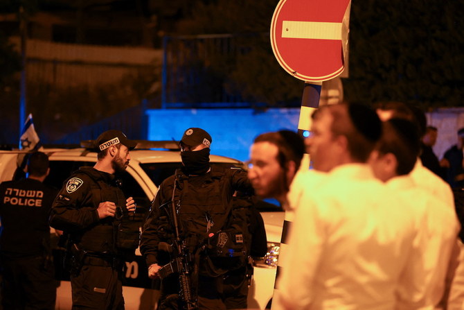 Local residents and Israeli security personnel gather in the area where at least three people were killed in what police suspect was a Palestinian attack, on Israeli Independence Day, in Elad. (Reuters)