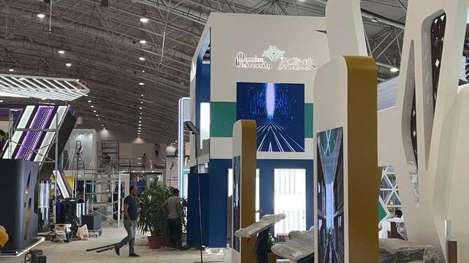 A worker is putting the finishing touches on the King Faisal University booth Saturday at the International Conference and Exhibition for Education (ICEE 2022) being held at the Riyadh International Convention and Exposition Center. (MoE/ Supplied)