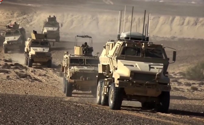 An image grab taken from a handout video released by the official Facebook page of Egypt's Military Spokesman on December 8, 2020 shows an Egyptian army armoured personnel carriers (APCs) driving in the desert. (File/AFP)