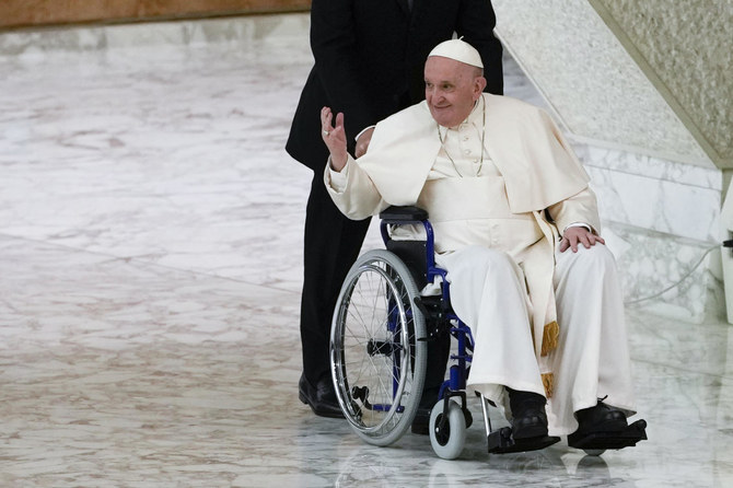 Pope Francis arrives in a wheelchair to attend an audience with nuns and religious superiors in the Paul VI Hall at The Vatican, May 5, 2022. (AP)