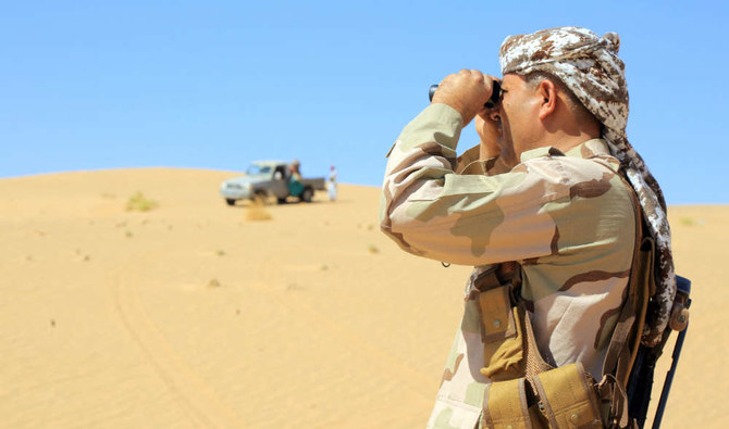 A fighter loyal to Yemen's government surveys the area at the al-Jawba frontline in the country's northeastern province of Maria. (AFP file photo)