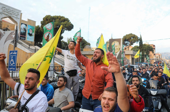 Lebanese youths hold a rally in Beirut's southern suburb on May 9, 2022, in support of the Shiite Hezbollah group and Amal movement candidates in the May 15 parliamentary elections. (Ibrahim Amro / AFP)