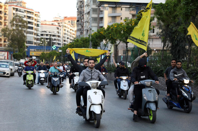 Lebanese youths hold a motorbike rally in Beirut's southern suburb on May 9, 2022, in support of the Shiite Hezbollah group and Amal movement candidates in the May 15 parliamentary elections. (Ibrahim Amro / AFP)