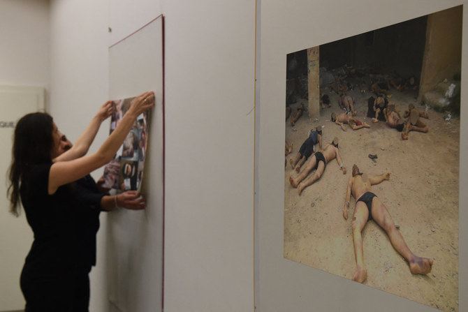 Syrian activists display pictures documenting the torture of detainees inside the Assad regime's detention centers on March 17, 2016 in Geneva. (AFP)