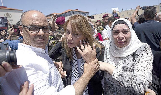 Palestinian friends and colleagues of slain journalist Shireen Abu Akleh cry and comfort each other during Thursday’s official ceremony in Ramallah. (AP)