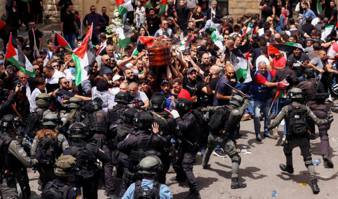 Family and friends carry the coffin of Al Jazeera reporter Shireen Abu Akleh as clashes erupted with Israeli security forces during her funeral in Jerusalem, May 13, 2022. (REUTERS)