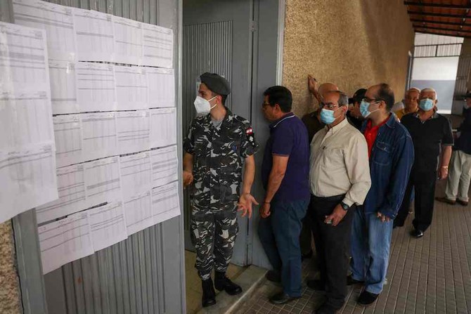 Lebanese voters queue outside a polling station near the Lebanese coastal city of Byblos on May 15, 2022. (AFP)