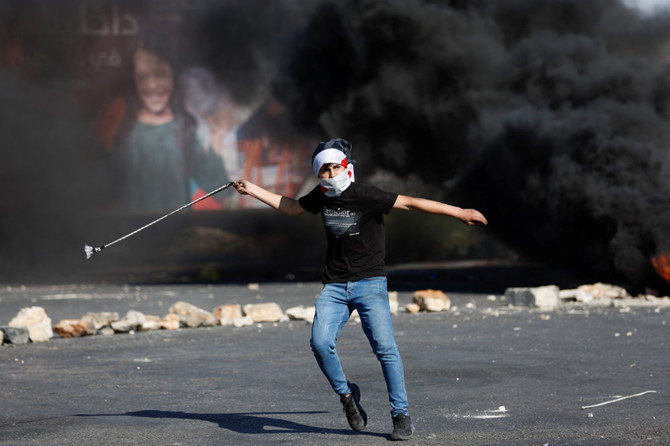 A demonstrator participates in clashes with the Israeli forces following a rally marking the 74th anniversary of Nakba or catastrophe, in Ramallah in the Israeli-occupied West Bank May 15, 2022. (Reuters)