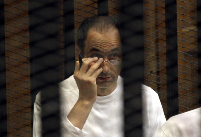 Gamal Mubarak sits behind bars at the second session of his trial on charges of insider trading in Cairo Criminal Court in Cairo, Egypt. (AP/File)