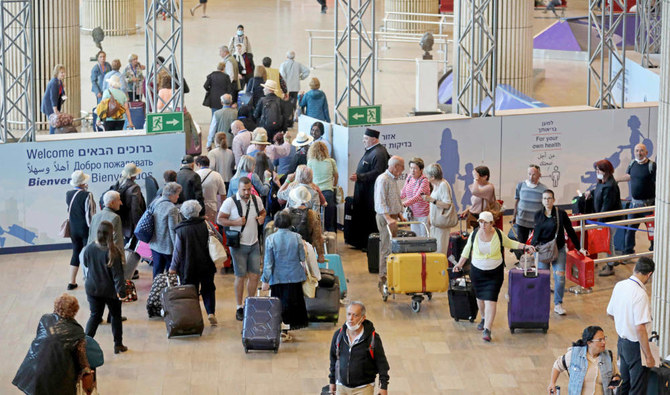 Passengers arrive at the COVID-19 testing site of Israel's Ben Gurion airport in Lod on May 19, 2022. (AFP)