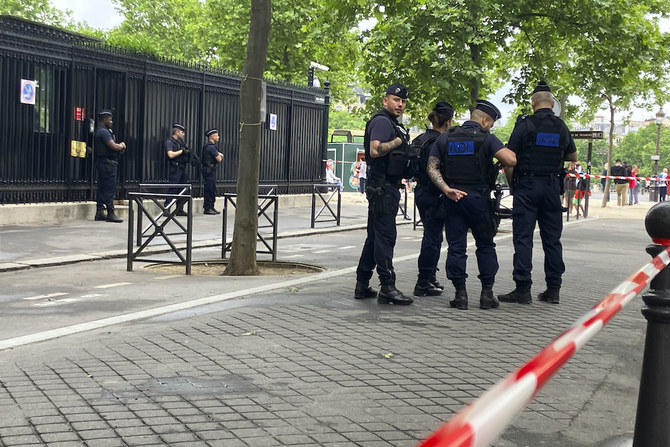 Police officers secure the entrance of the Qatar embassy in Paris on May 23, 2022 after a watchman was killed. (AP)