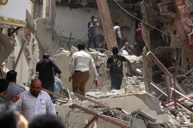 At least 10 people died and about 80 were trapped under rubble when an unfinished building collapsed in southwestern Iran, officials said. (TASNIM NEWS/AFP)