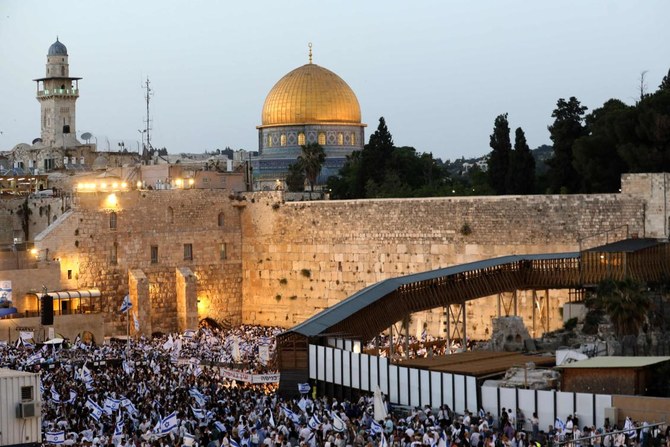 Demonstrators gather with Israeli flags at the Western Wall in the old city of Jerusalem on May 29, 2022, during the Israeli “flags march” to mark “Jerusalem Day.” (AFP)