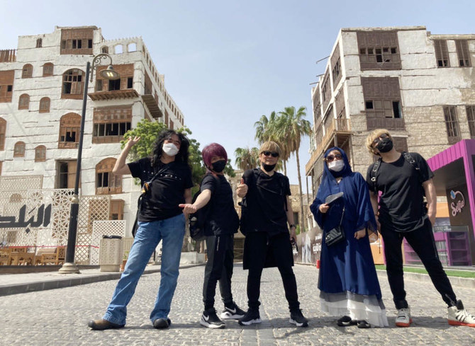 On Saturday, the band went sightseeing in historical Jeddah. Okui, the only female in the group, wore a navy abaya and covered her hair like a Saudi woman.