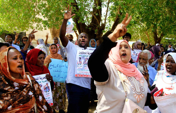 Sudanese protesters rally outside a court in Khartoum on Sunday to support fellow demonstrators charged with the reported killing of a police officer. (AFP)