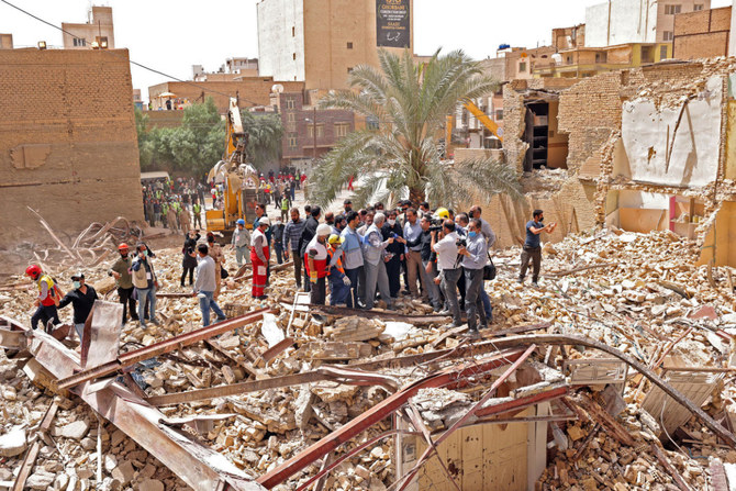 Iranian vice president Mohammad Mokhber (C) visits the site where a 10-storey building collapsed in the southwestern city of Abadan on May 27, 2022. (Iran presidency handout via AFP)